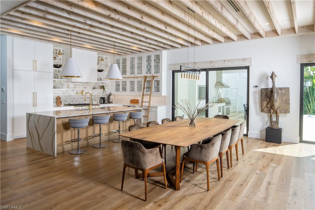 3770 Crayton Road Naples, FL 34103 - Photo 5 of 26 a view of a dining room with furniture and wooden floor