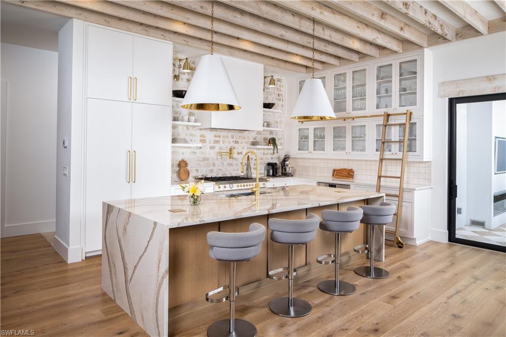 3770 Crayton Road Naples, FL 34103 - Photo 6 of 26 a kitchen with stainless steel appliances granite countertop a sink and cabinets