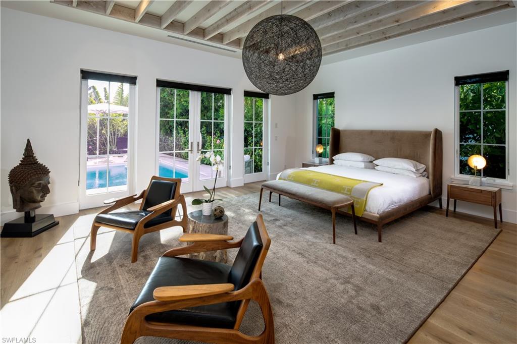 3770 Crayton Road Naples, FL 34103 - Photo 8 of 26 a bedroom with furniture and a large window