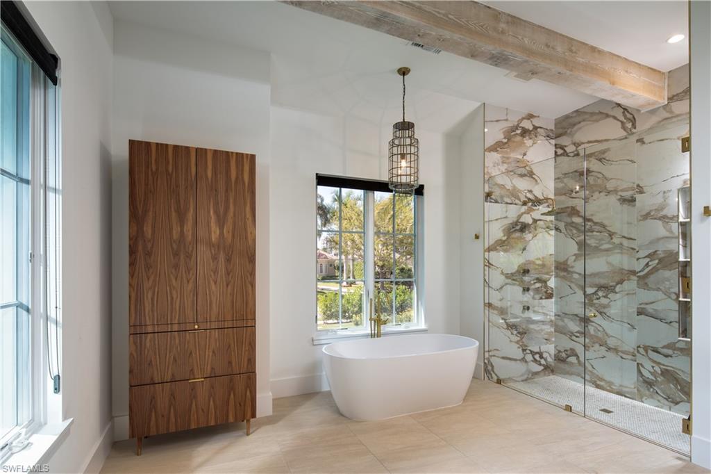 3770 Crayton Road Naples, FL 34103 - Photo 9 of 26 a bathroom with a bathtub and shower