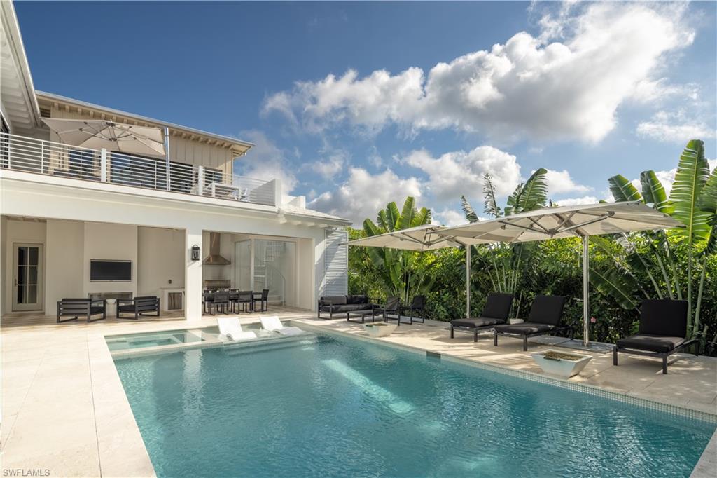 3770 Crayton Road Naples, FL 34103 - Photo 10 of 26 a view of a house with swimming pool and sitting area
