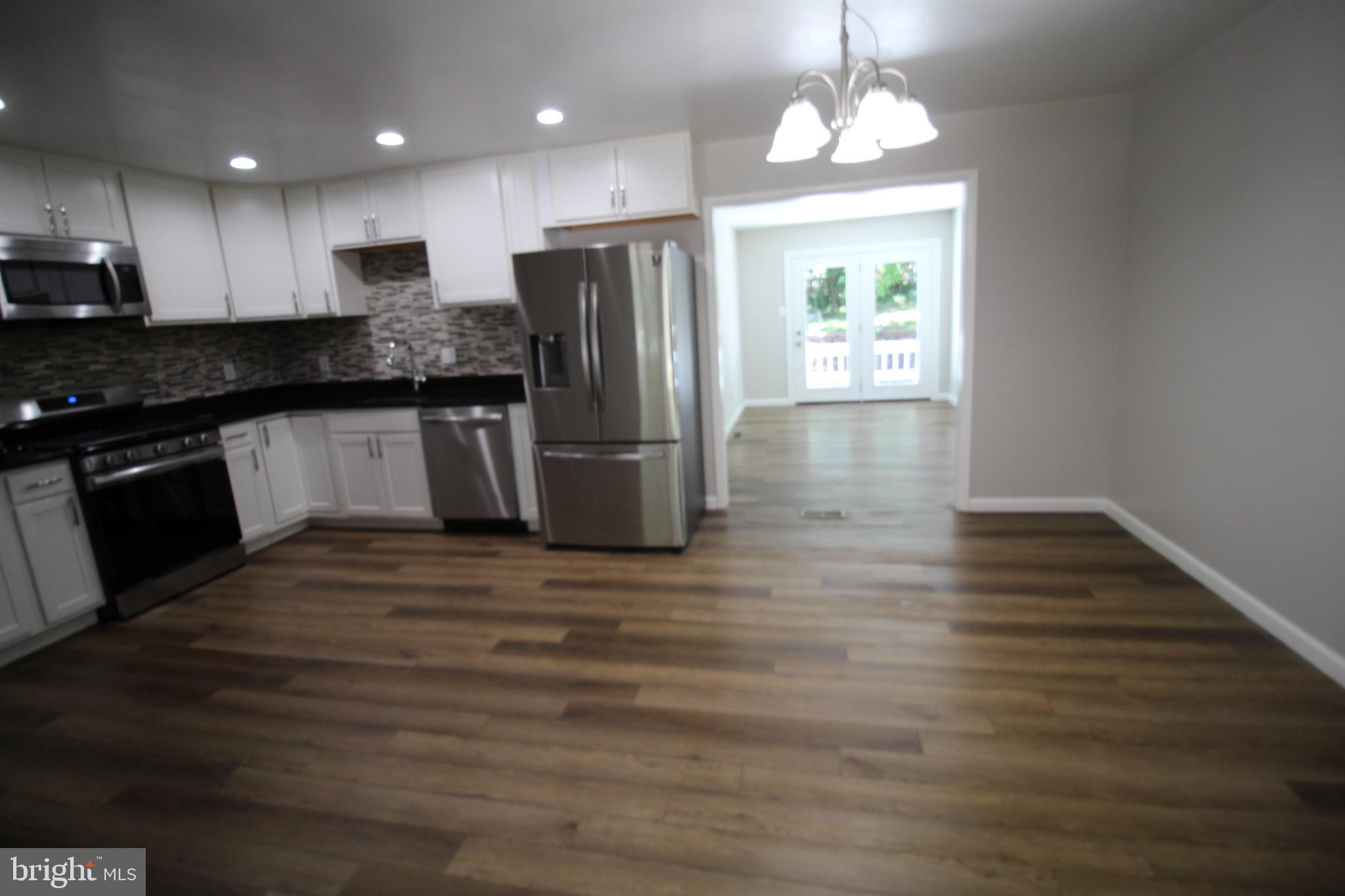 9003 Anna Drive Clinton, MD 20735 - Photo 14 of 41 a kitchen with a refrigerator and a stove top oven