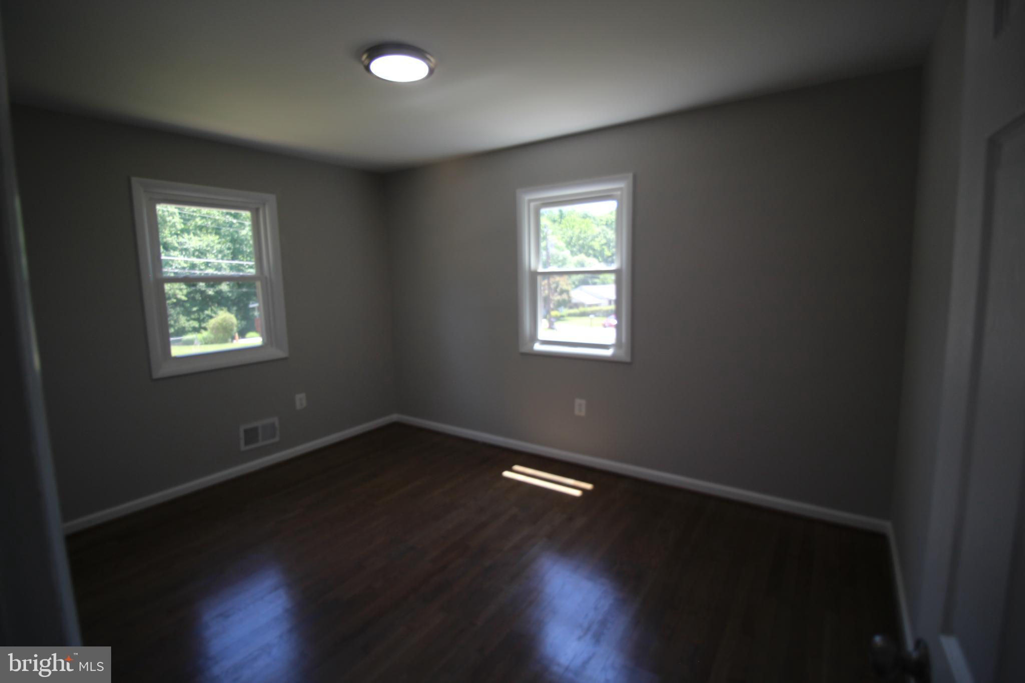 9003 Anna Drive Clinton, MD 20735 - Photo 19 of 41 a view of an empty room with wooden floor and a window