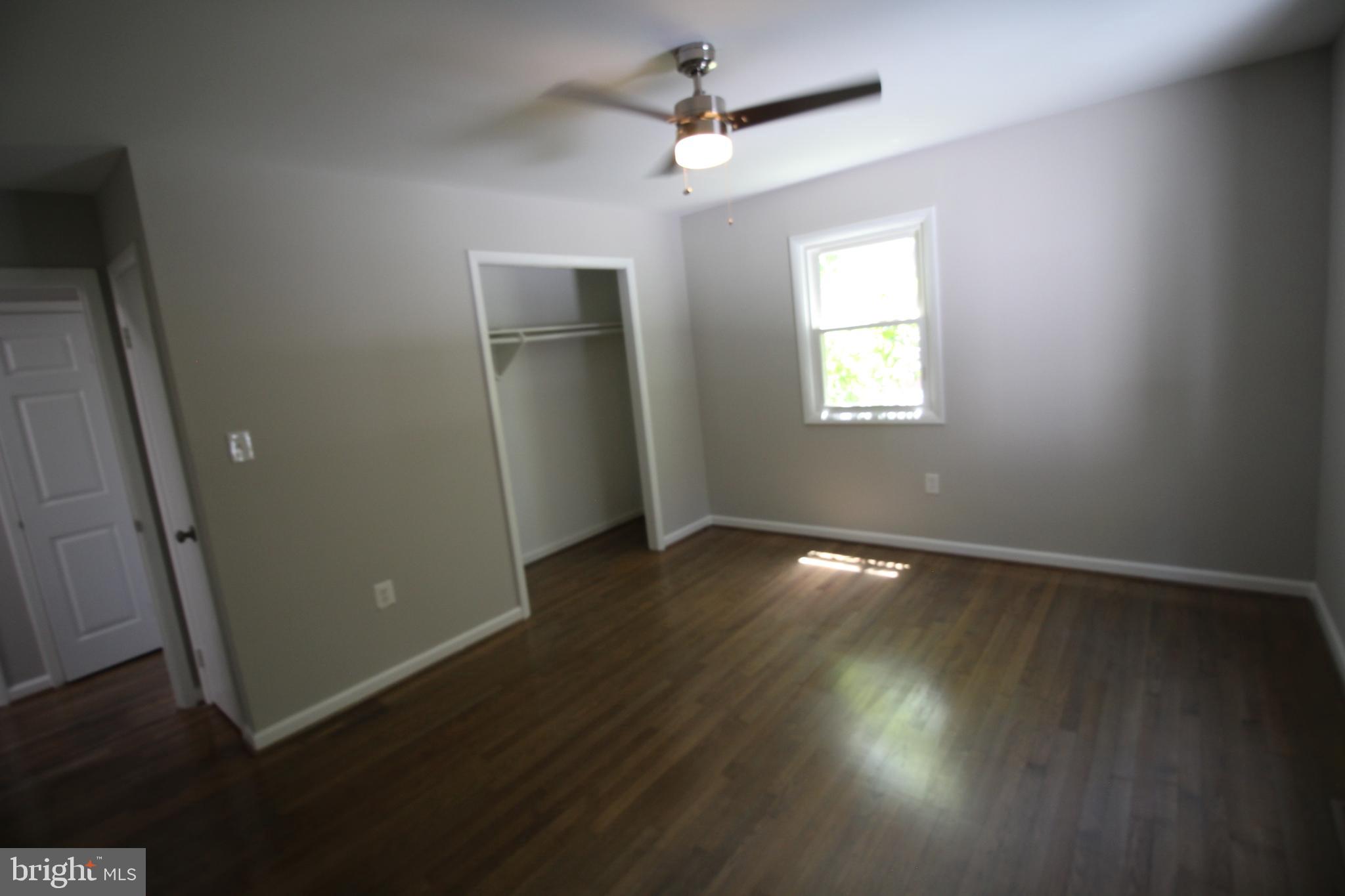 9003 Anna Drive Clinton, MD 20735 - Photo 20 of 41 an empty room with wooden floor and windows