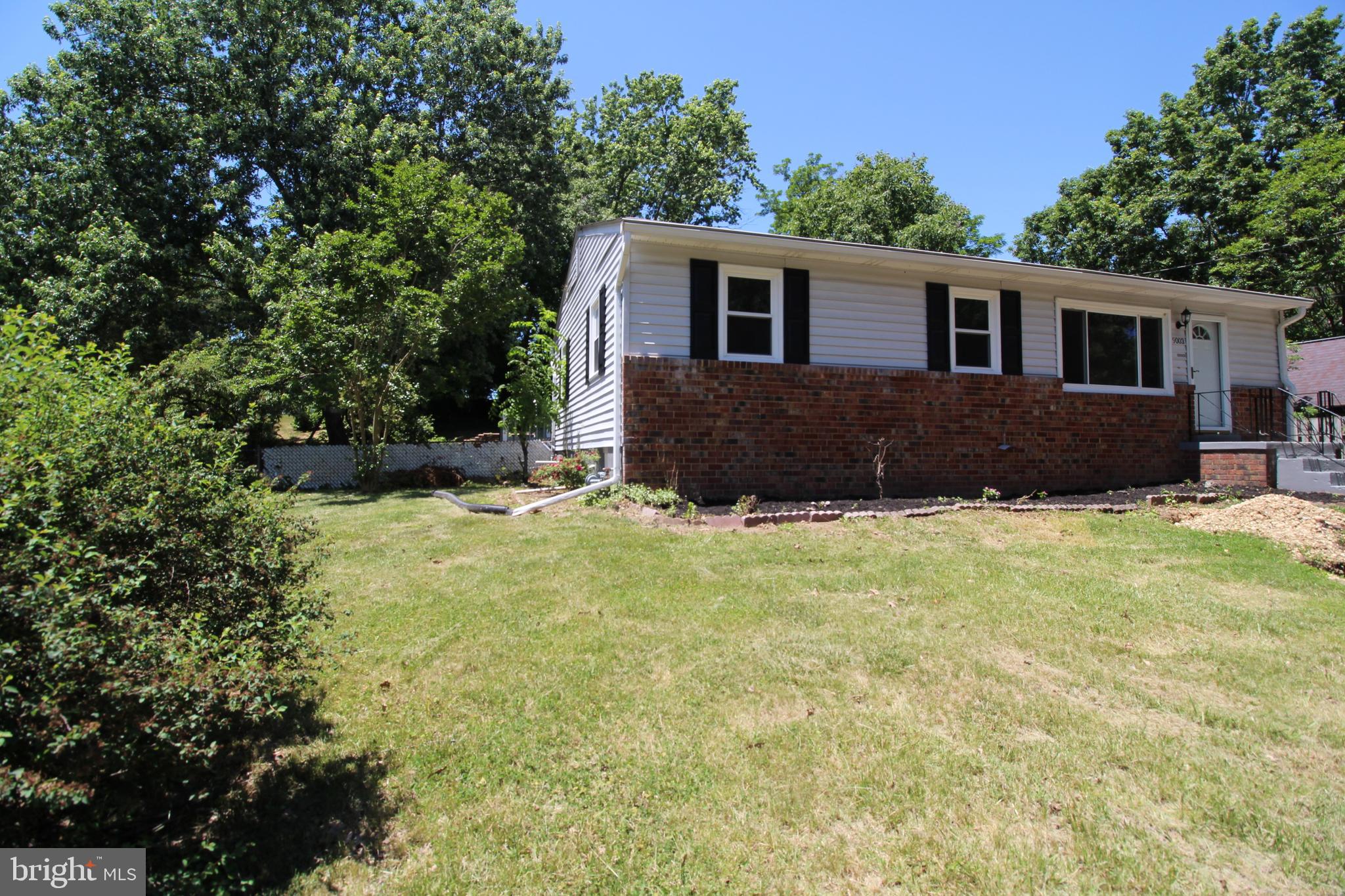 9003 Anna Drive Clinton, MD 20735 - Photo 2 of 41 a house that has a big yard with large trees