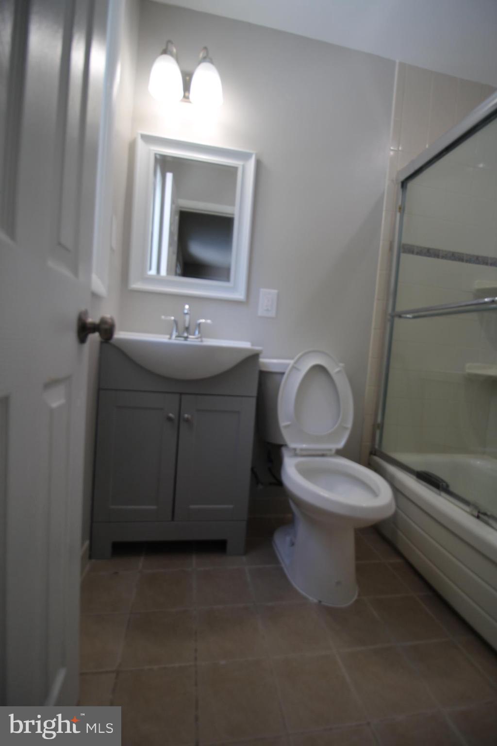 9003 Anna Drive Clinton, MD 20735 - Photo 22 of 41 a bathroom with a toilet sink and mirror
