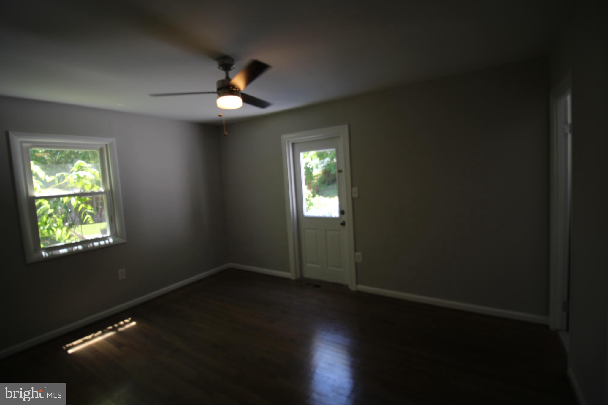9003 Anna Drive Clinton, MD 20735 - Photo 23 of 41 a view of an empty room with wooden floor and a window