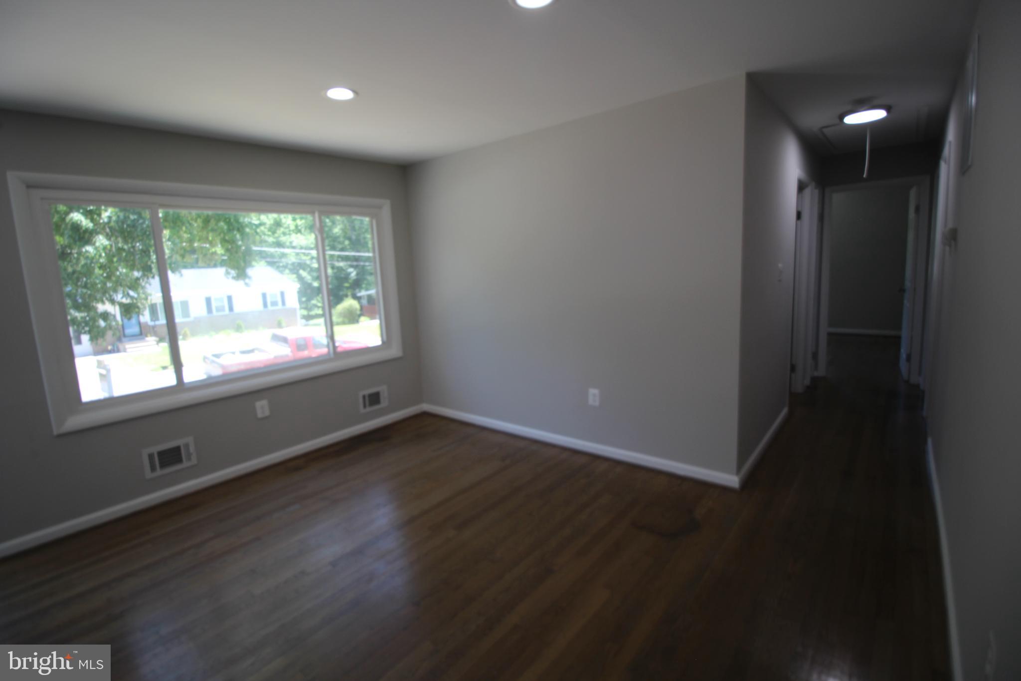 9003 Anna Drive Clinton, MD 20735 - Photo 26 of 41 an empty room with wooden floor and windows