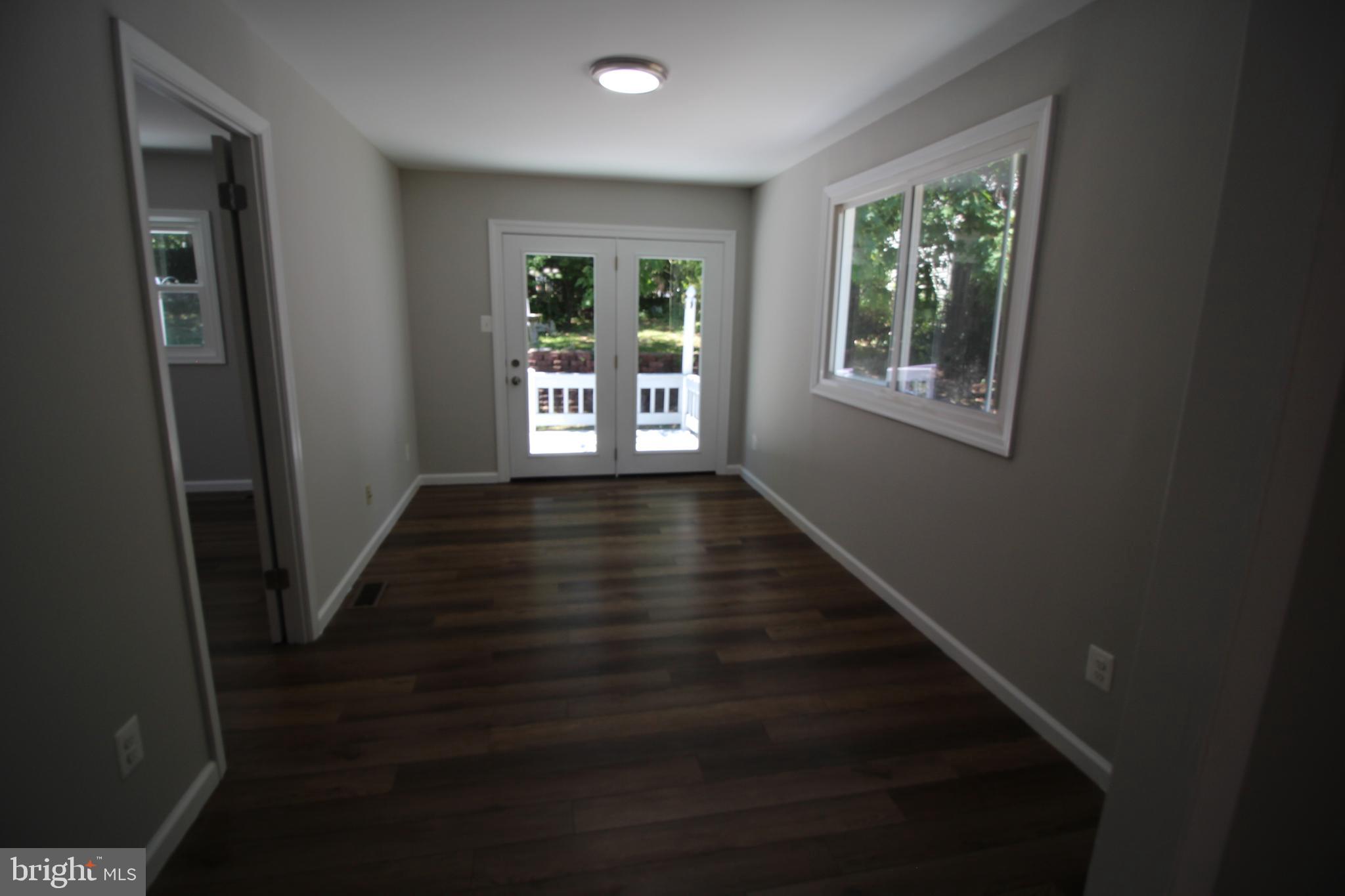 9003 Anna Drive Clinton, MD 20735 - Photo 28 of 41 a view of an empty room with wooden floor and a window