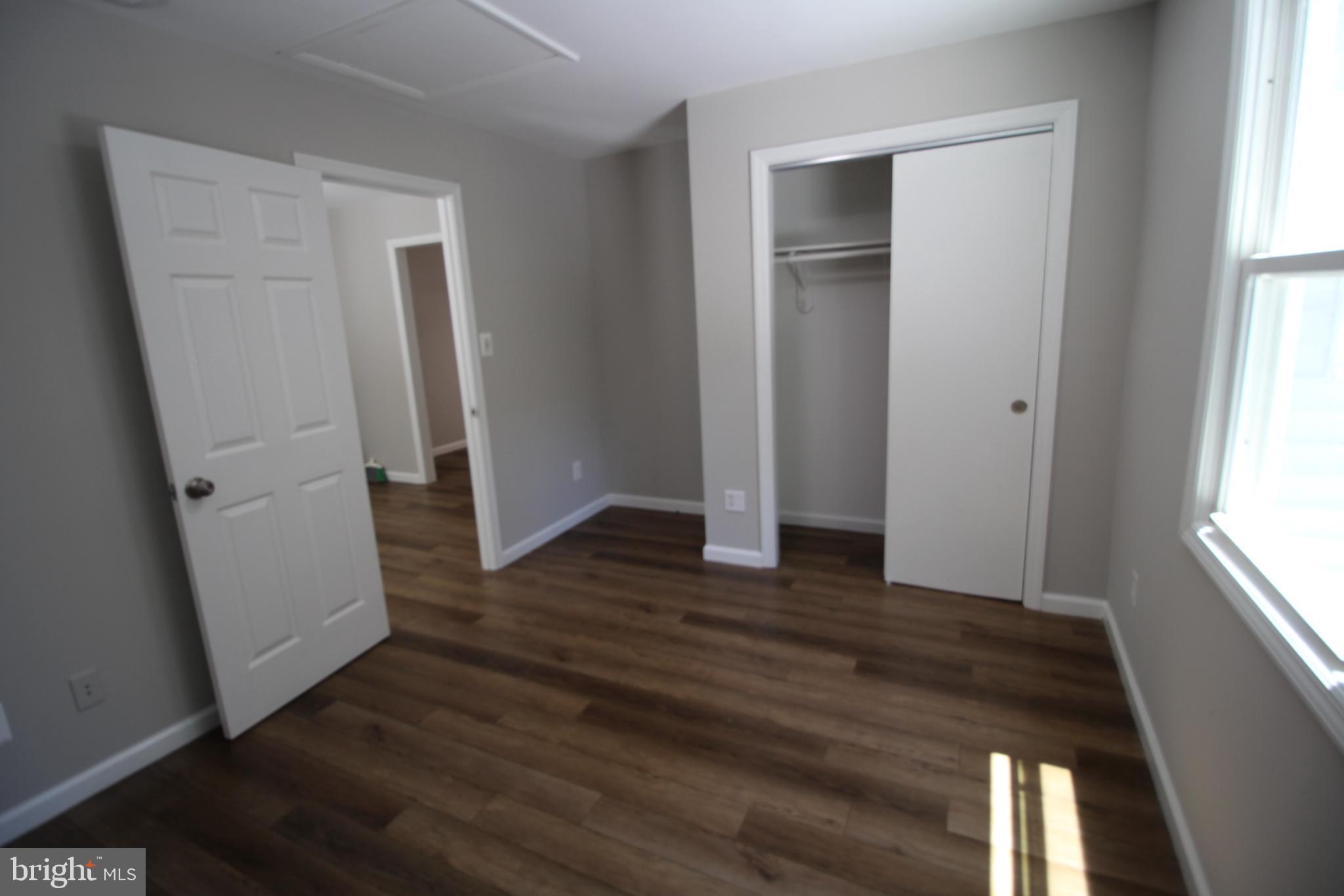 9003 Anna Drive Clinton, MD 20735 - Photo 29 of 41 an empty room with wooden floor and windows