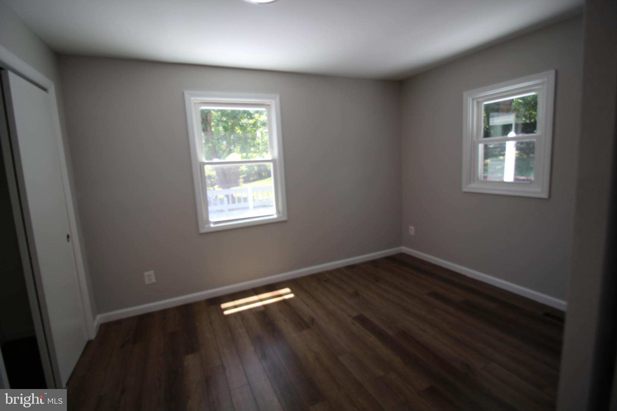 9003 Anna Drive Clinton, MD 20735 - Photo 30 of 41 an empty room with wooden floor and windows