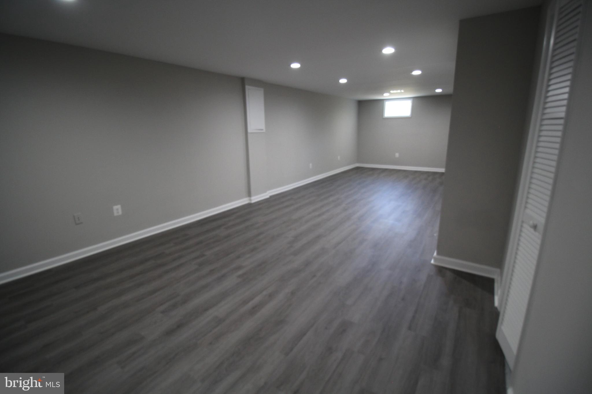 9003 Anna Drive Clinton, MD 20735 - Photo 32 of 41 an empty room with wooden floor and windows