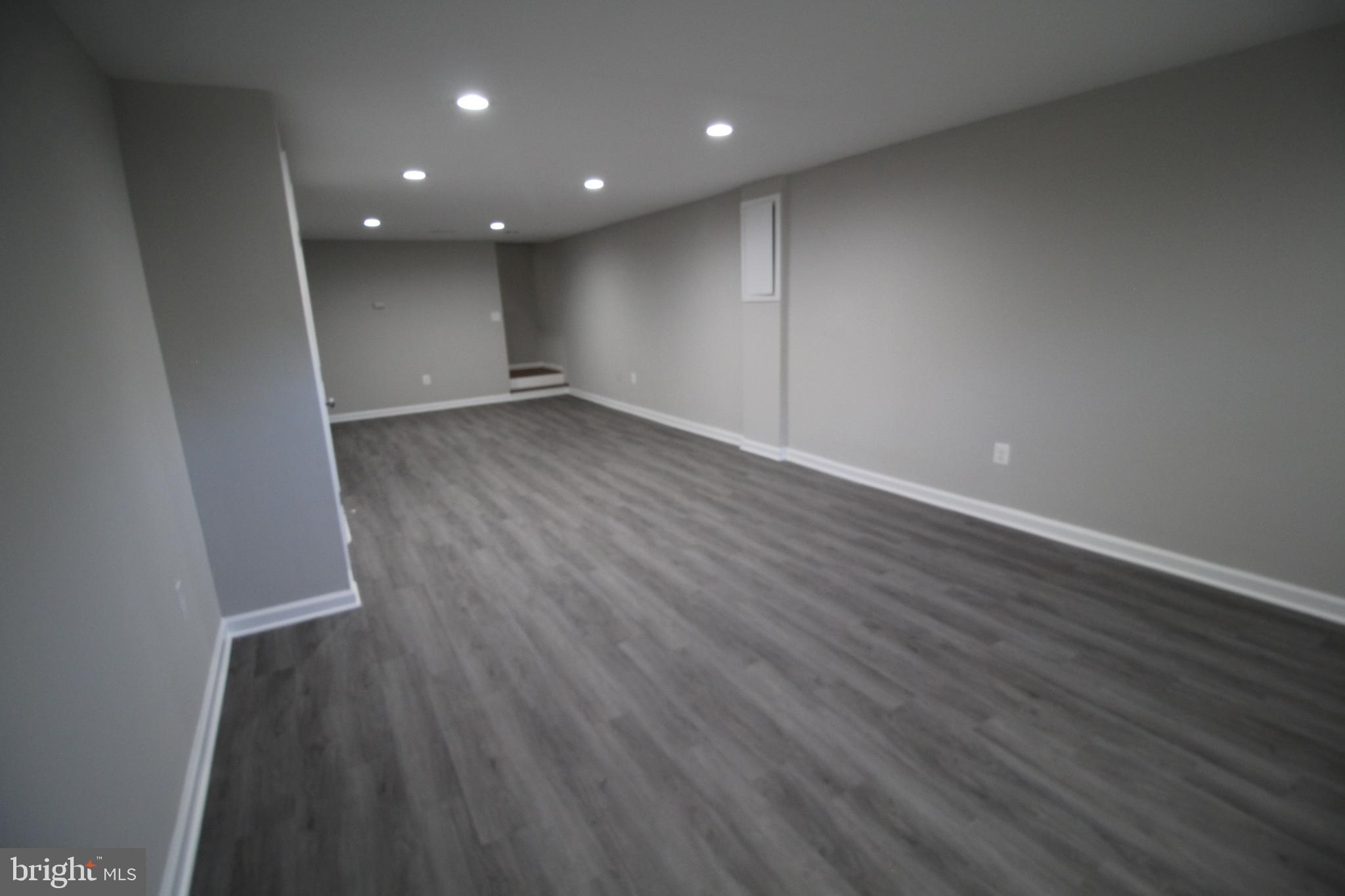 9003 Anna Drive Clinton, MD 20735 - Photo 34 of 41 an empty room with wooden floor and windows