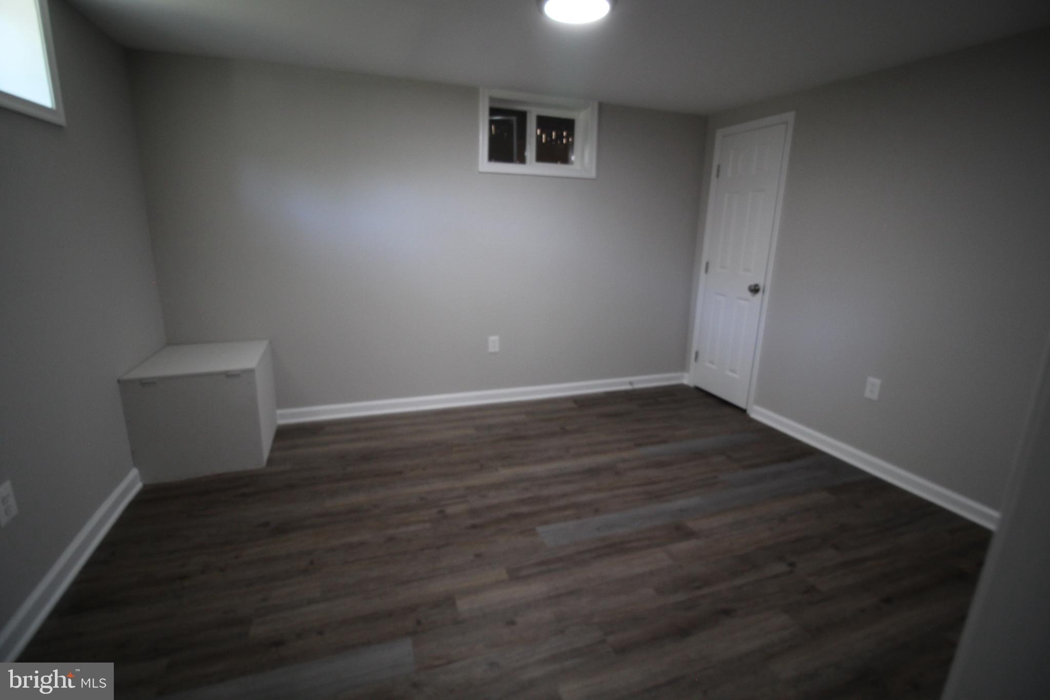 9003 Anna Drive Clinton, MD 20735 - Photo 37 of 41 a view of an empty room with wooden floor and a window