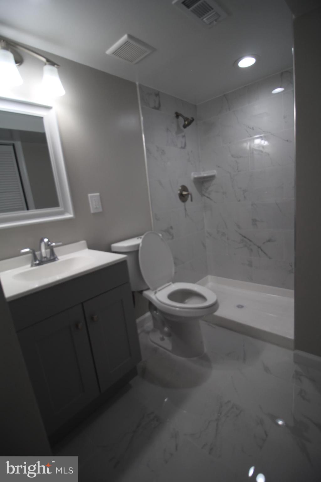 9003 Anna Drive Clinton, MD 20735 - Photo 38 of 41 a bathroom with a sink a toilet and shower