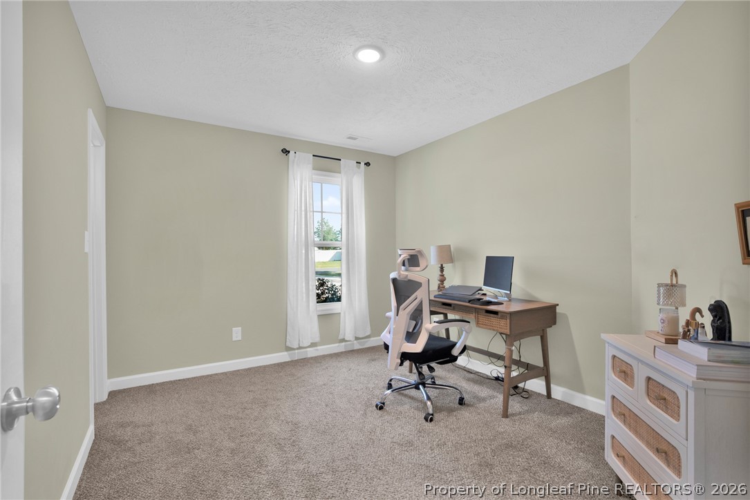 351 Sandy Grove Road Parkton, NC 28371 - Photo 14 of 30 a view of a workspace with furniture and a window