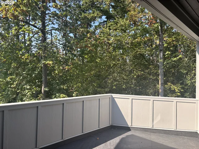 a view of a balcony with trees
