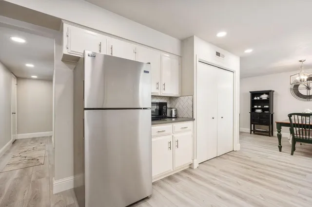 a kitchen with stainless steel appliances a refrigerator and a stove top oven