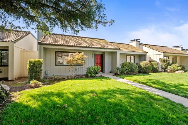 a front view of a house with garden