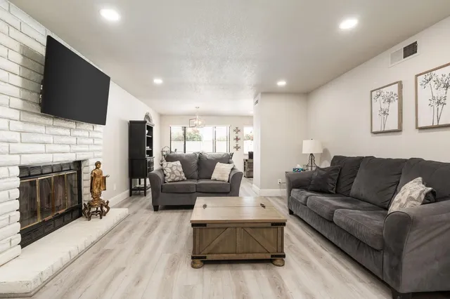 a living room with fireplace furniture and a flat screen tv