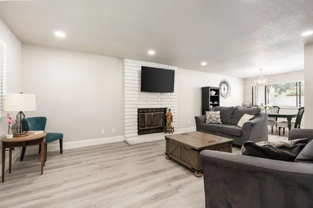 a living room with furniture a fireplace and a flat screen tv