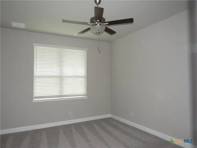 a view of a room with a window and a fan