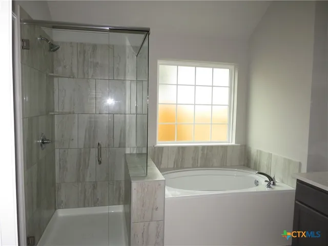 a bathroom with a bathtub and shower