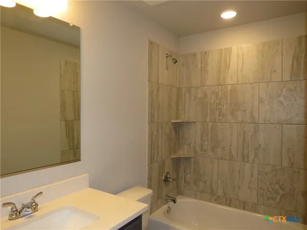 a bathroom with a bathtub and a sink