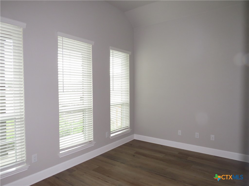 5737 Redfish Court Belton, TX 76513 - Photo 5 of 20 an empty room with wooden floor and windows