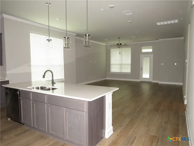 a view of a sink a faucet and chandelier in a room