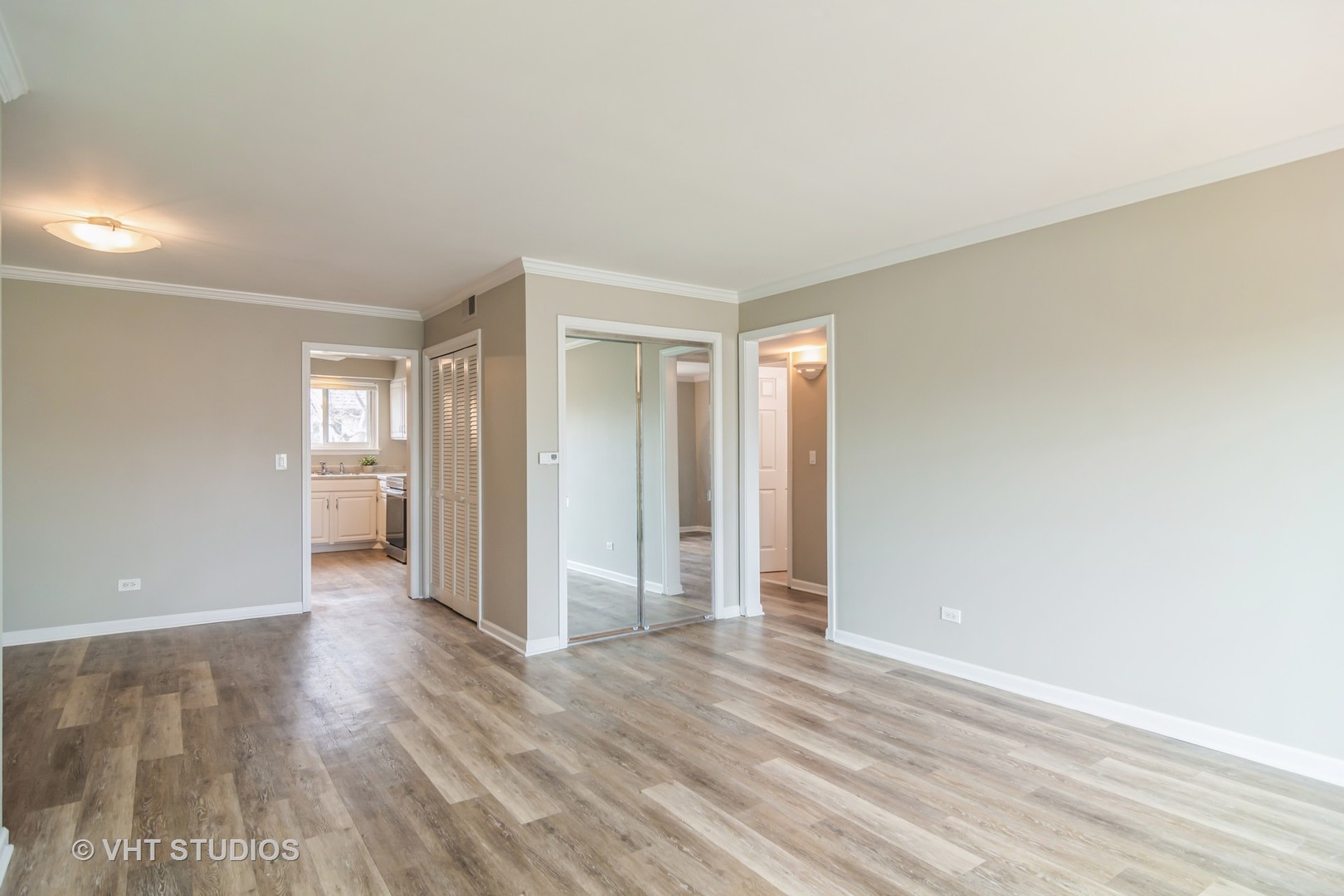 904 South Plum Grove Road, Unit 202 Palatine, IL 60067 - Photo 2 of 14 an empty room with wooden floor & windows