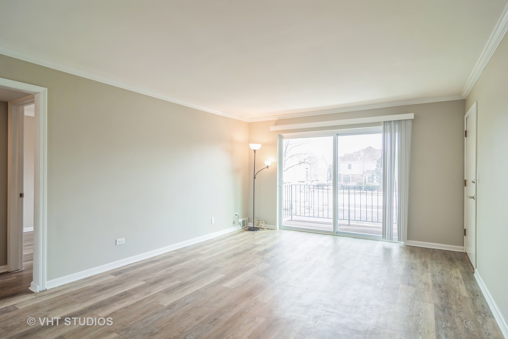 904 South Plum Grove Road, Unit 202 Palatine, IL 60067 - Photo 3 of 14 an empty room with wooden floor and windows