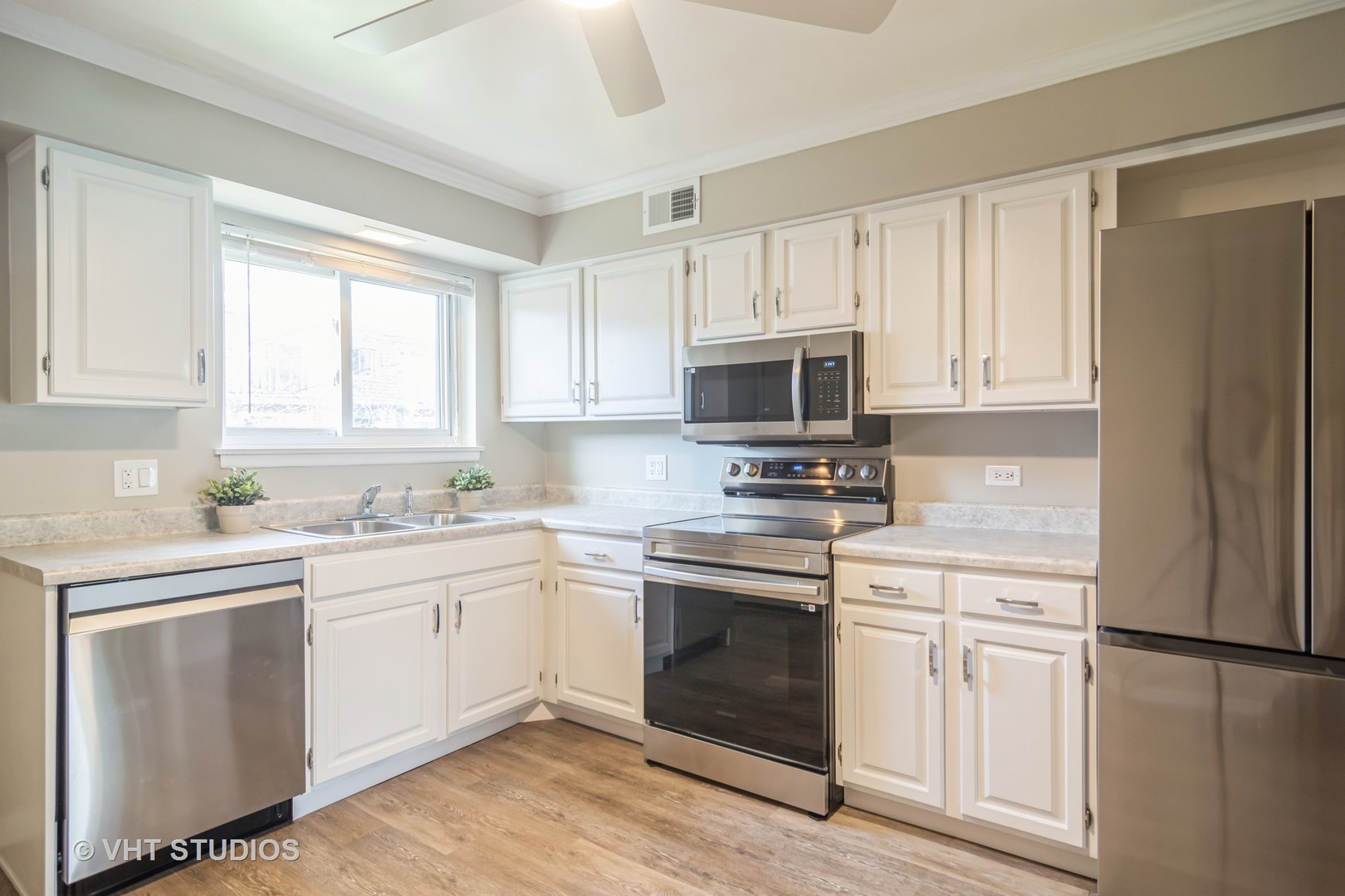 904 South Plum Grove Road, Unit 202 Palatine, IL 60067 - Photo 6 of 14 a kitchen with white cabinets and white appliances