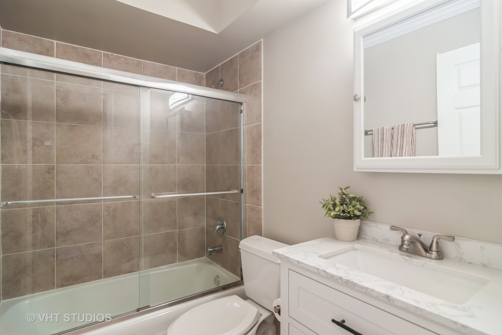 904 South Plum Grove Road, Unit 202 Palatine, IL 60067 - Photo 8 of 14 a bathroom with a sink toilet and shower