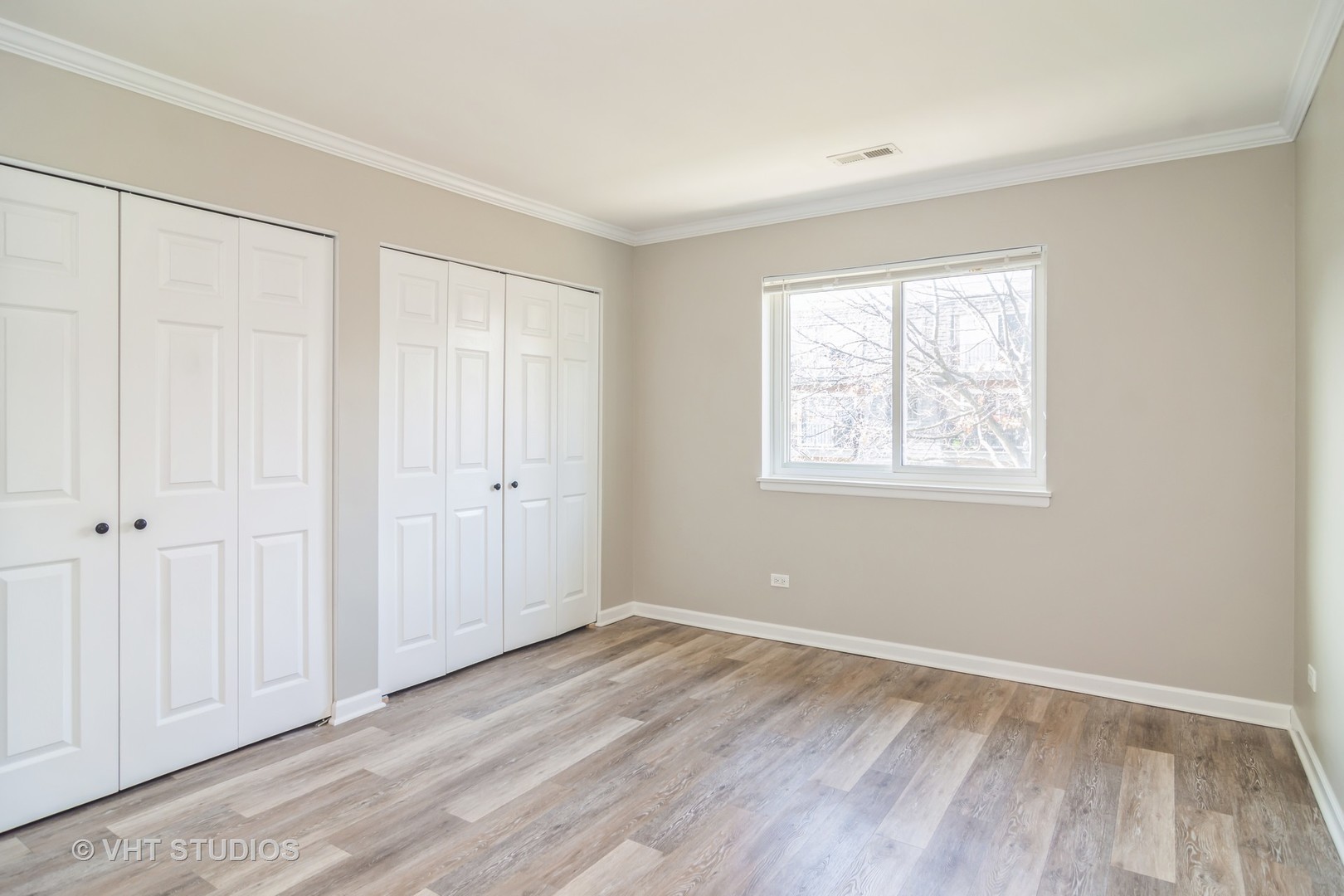 904 South Plum Grove Road, Unit 202 Palatine, IL 60067 - Photo 9 of 14 a view of an empty room with wooden floor and a window