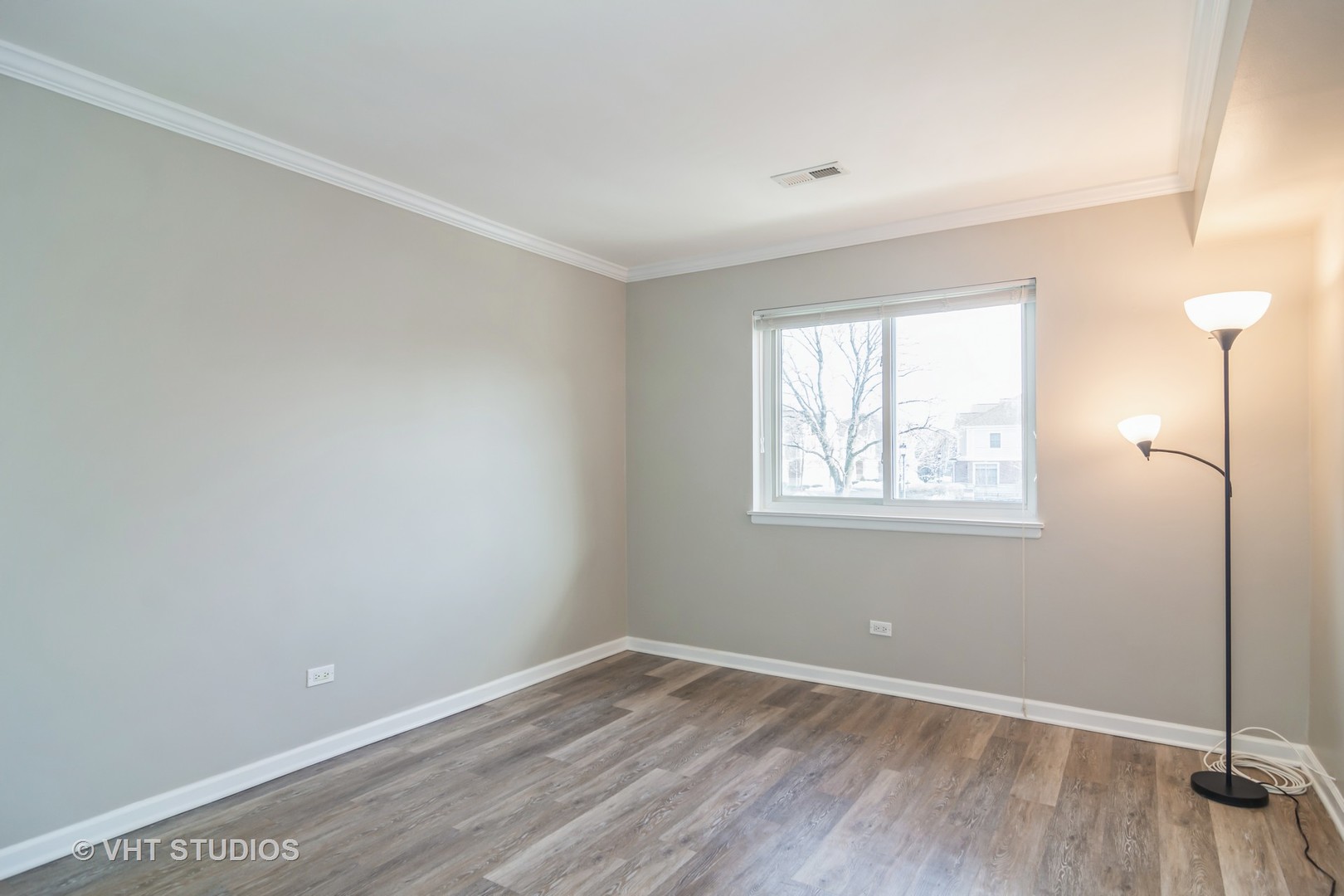 904 South Plum Grove Road, Unit 202 Palatine, IL 60067 - Photo 10 of 14 an empty room with wooden floor and windows