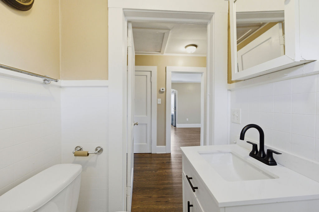 7604 Highway 252 Honea Path, SC 29654 - Photo 22 of 33 This clean and inviting bathroom features classic white tile and a modern black faucet.