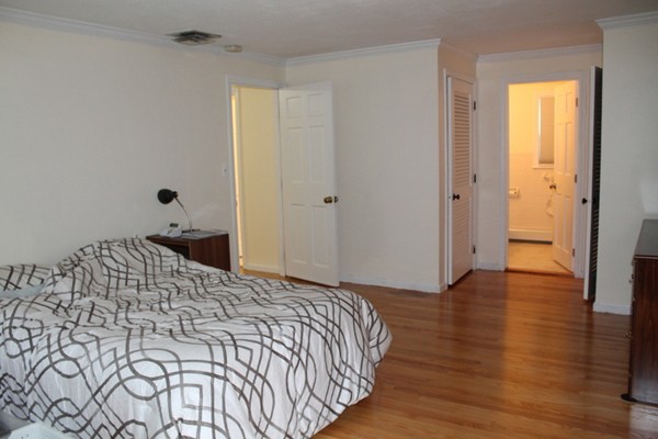23 West Colonial Road Wilbraham, MA 01095 - Photo 12 of 30 a bedroom with a bed and wooden floor