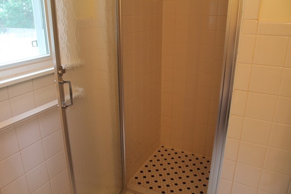 23 West Colonial Road Wilbraham, MA 01095 - Photo 14 of 30 a bathroom with a shower curtain and a window