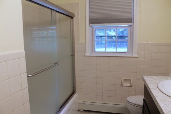 23 West Colonial Road Wilbraham, MA 01095 - Photo 16 of 30 a bathroom with a granite countertop toilet and a shower