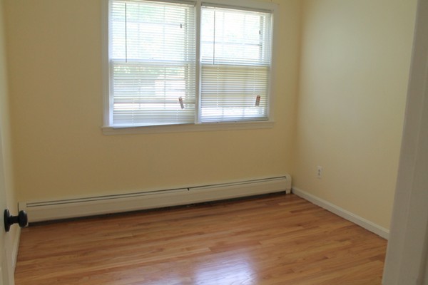 23 West Colonial Road Wilbraham, MA 01095 - Photo 17 of 30 an empty room with wooden floor and windows