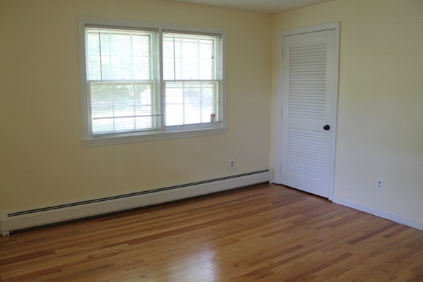 23 West Colonial Road Wilbraham, MA 01095 - Photo 20 of 30 an empty room with wooden floor and windows