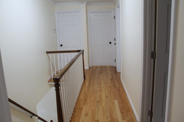 23 West Colonial Road Wilbraham, MA 01095 - Photo 21 of 30 a view of a hallway with wooden floor and staircase