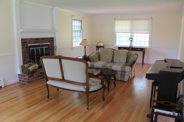 23 West Colonial Road Wilbraham, MA 01095 - Photo 3 of 30 a living room with furniture a fireplace and a window
