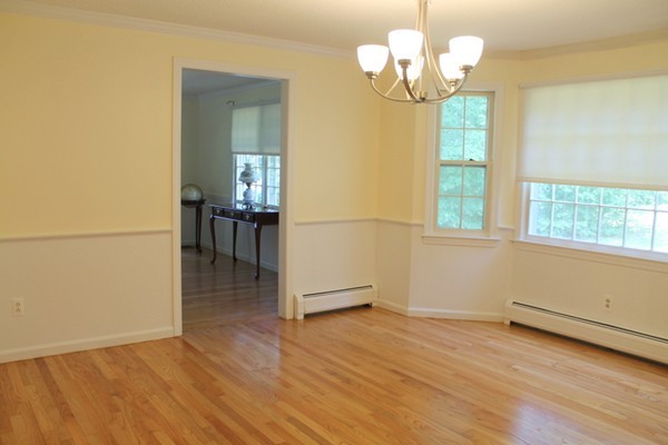 23 West Colonial Road Wilbraham, MA 01095 - Photo 5 of 30 a view of a room with wooden floor and chandelier
