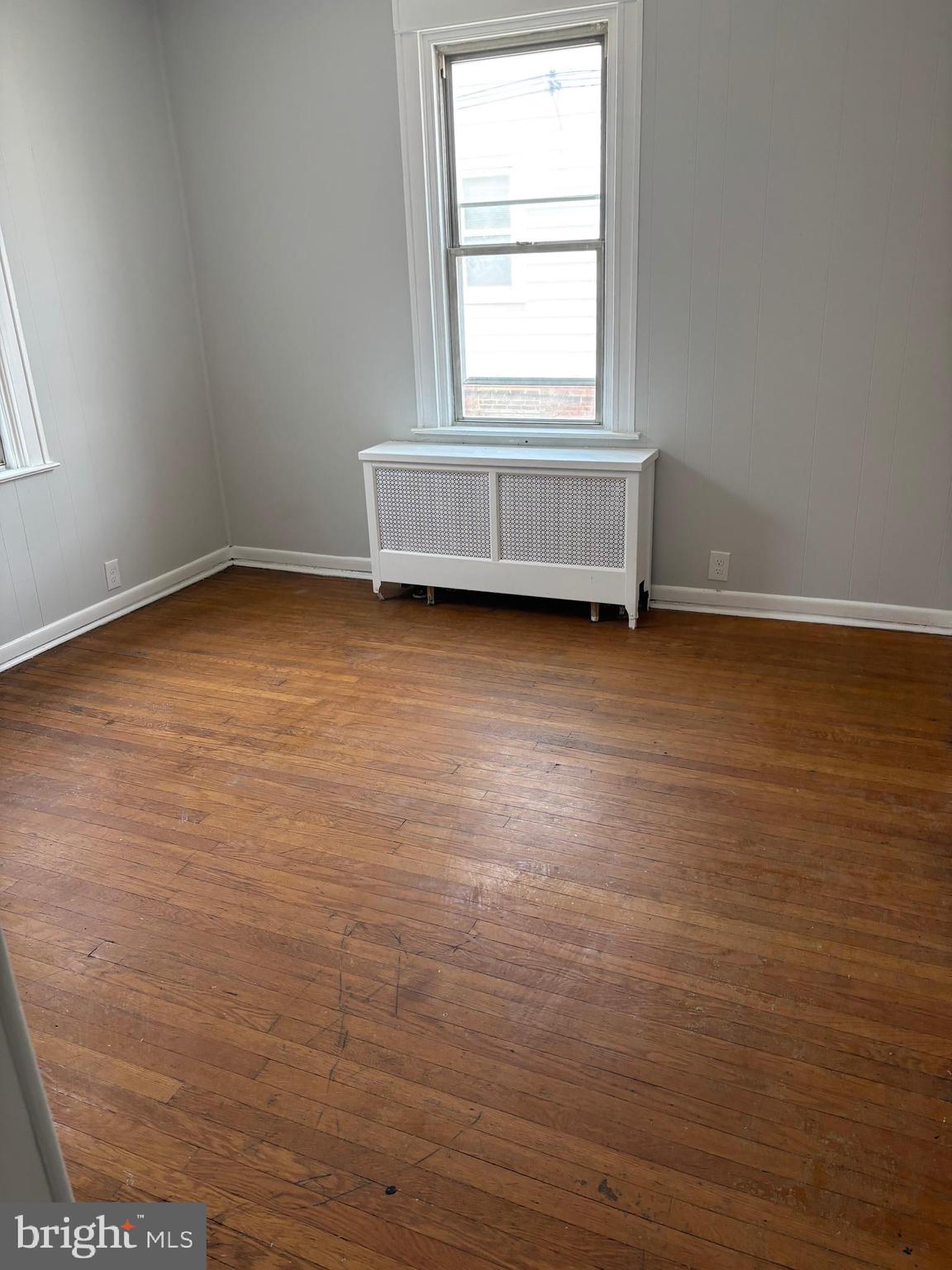 227 Wembly Road Upper Darby, PA 19082 - Photo 12 of 19 an empty room with wooden floor and windows