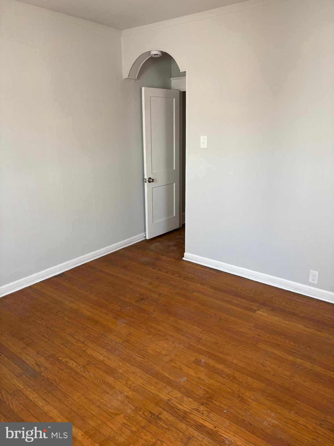 227 Wembly Road Upper Darby, PA 19082 - Photo 13 of 19 an empty room with wooden floor cabinet and a window