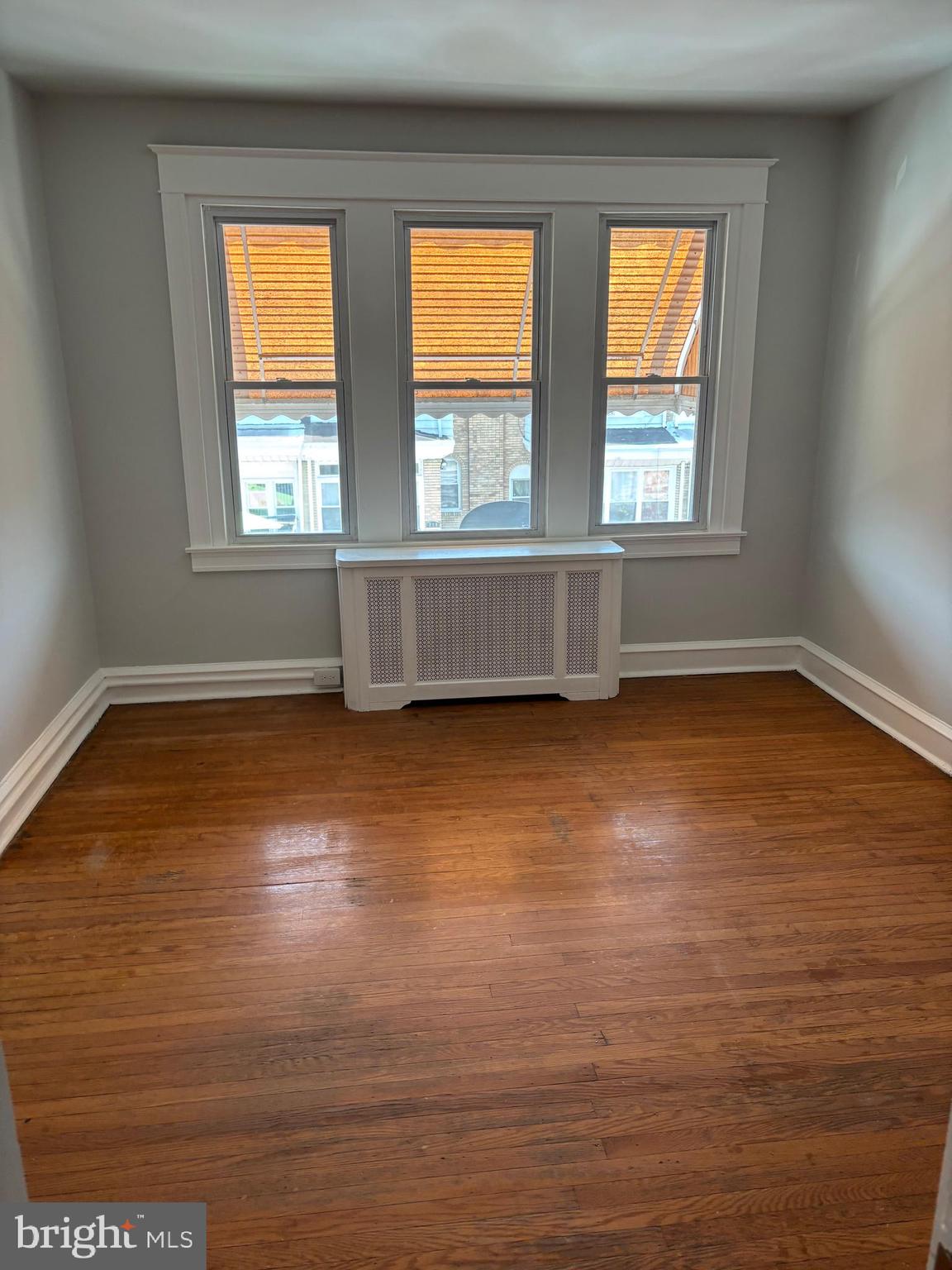 227 Wembly Road Upper Darby, PA 19082 - Photo 16 of 19 an empty room with wooden floor and windows