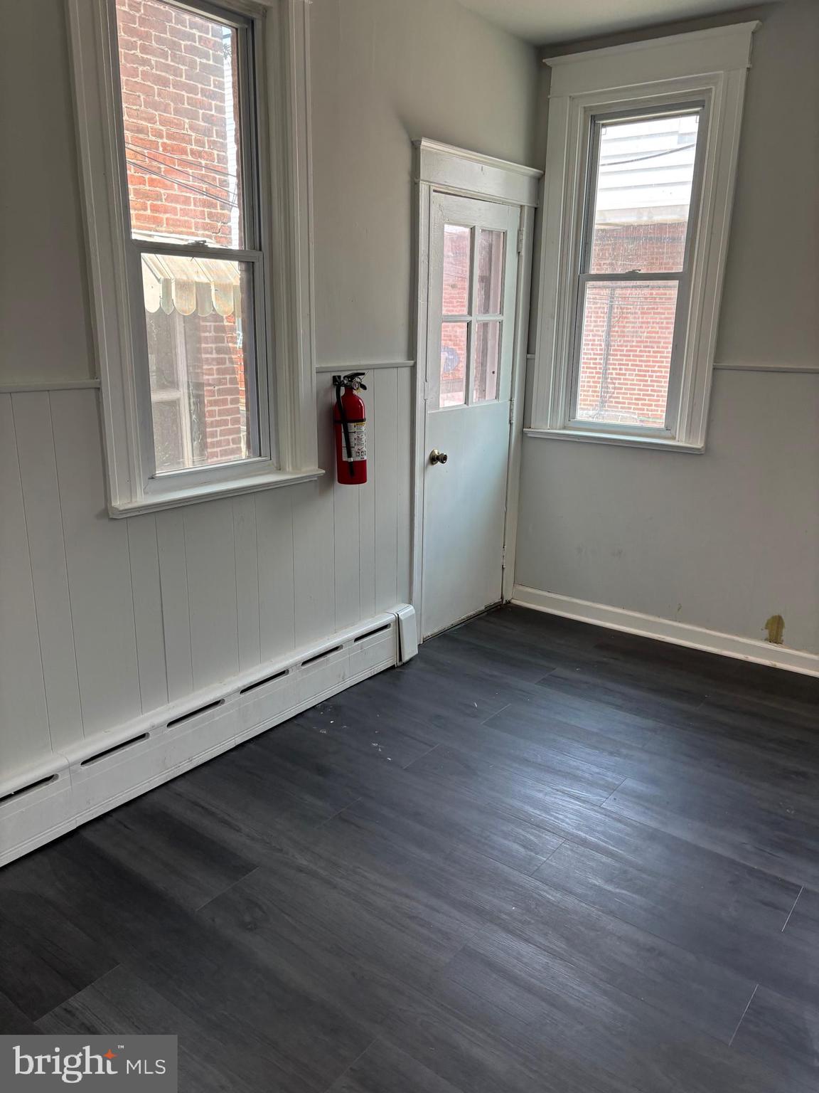227 Wembly Road Upper Darby, PA 19082 - Photo 10 of 19 an empty room with wooden floor and windows