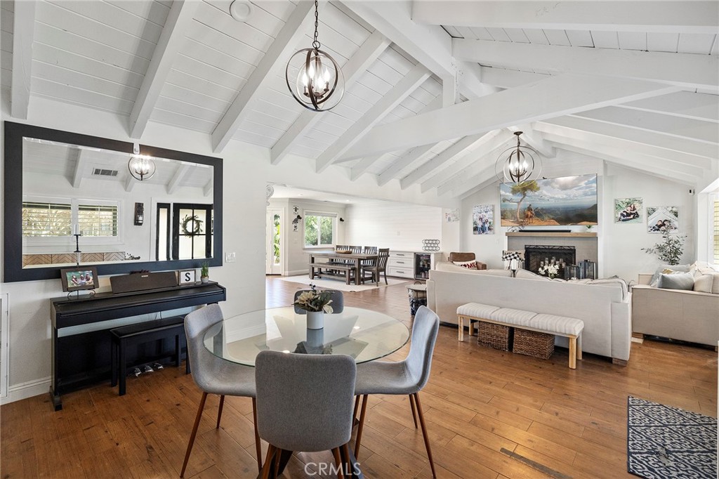 41480 Luz Del Sol Temecula, CA 92591 - Photo 11 of 44 a view of a dining room with furniture a chandelier and wooden floor